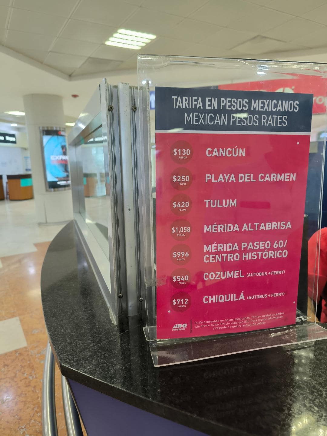 Tabuľa s aktuálnymi cenami za lístok na autobus z letiska do Cancúnu.